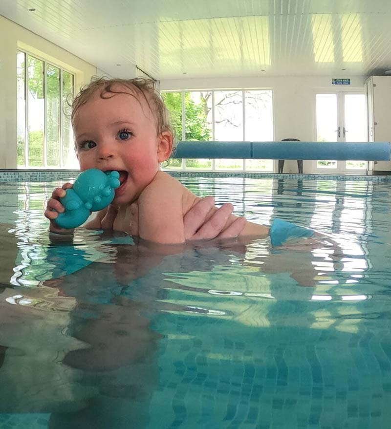 6 month old swimming in a pool